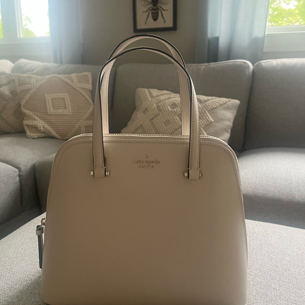 Kate Spade.Never used, bone white,gold logo. Strap is long enough for crossbody